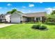 Charming single-story home with a two-car garage, brick accents, and manicured lawn at 7437 Lorene Ct, Indianapolis, IN 46237