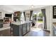 Open kitchen with center island/bar seating, sliding doors to the backyard, and an inviting atmosphere at 7437 Lorene Ct, Indianapolis, IN 46237