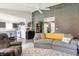 Open-concept living room with gray sofas, high ceiling, and seamlessly connected kitchen area at 7437 Lorene Ct, Indianapolis, IN 46237