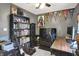 Inviting office space with sports decor, ceiling fan, television, desk, shelving, and a well-organized bookcase at 7437 Lorene Ct, Indianapolis, IN 46237