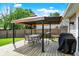Outdoor patio with a gazebo, dining table, chairs, BBQ and wooden deck; ideal for entertaining at 7437 Lorene Ct, Indianapolis, IN 46237