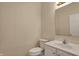Powder room features a modern toilet, white vanity and framed mirror, offering a blend of comfort and convenience at 7637 Sand Run Ct, Indianapolis, IN 46259