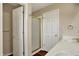 A bathroom featuring dual sinks, a stand up shower, and multiple doors at 7637 Sand Run Ct, Indianapolis, IN 46259