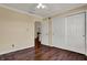 Bedroom with hardwood floors, double closets, and access to hallway at 7637 Sand Run Ct, Indianapolis, IN 46259