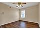 Bedroom featuring hardwood floors, a window, and ceiling fan with light fixture at 7637 Sand Run Ct, Indianapolis, IN 46259