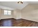 An empty bedroom featuring a window, wood floors, and a ceiling fan with lighting at 7637 Sand Run Ct, Indianapolis, IN 46259