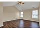 An empty bedroom featuring two windows, wood floors, and a vaulted ceiling at 7637 Sand Run Ct, Indianapolis, IN 46259