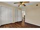 Bedroom with hardwood floors, double closets, and ceiling fan with light at 7637 Sand Run Ct, Indianapolis, IN 46259