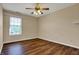 Bedroom featuring hardwood floors, a window, and ceiling fan with light at 7637 Sand Run Ct, Indianapolis, IN 46259