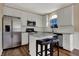 Modern kitchen featuring stainless steel appliances, white cabinets, and a breakfast bar with seating at 7637 Sand Run Ct, Indianapolis, IN 46259