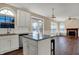 Open eat-in kitchen featuring granite countertops and stainless steel appliances and view to living room at 7637 Sand Run Ct, Indianapolis, IN 46259