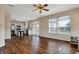 Open living area with hardwood flooring, a ceiling fan, and view to the kitchen with stainless steel appliances at 7637 Sand Run Ct, Indianapolis, IN 46259
