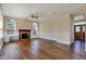 Inviting living room with wood floors, fireplace, arched windows, and natural light at 7637 Sand Run Ct, Indianapolis, IN 46259