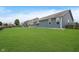 Large backyard with a lush lawn, privacy fence, and blue siding on the house at 7724 Dunleer Dr, Brownsburg, IN 46112