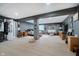 Open concept basement displaying living and sleeping spaces with neutral walls and vinyl floors at 7724 Dunleer Dr, Brownsburg, IN 46112