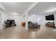 Spacious finished basement featuring a home office setup, multiple seating areas, and recessed lighting at 7724 Dunleer Dr, Brownsburg, IN 46112