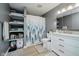 Well-lit bathroom with storage shelves, a shower with forest curtain, and vanity with a sink at 7724 Dunleer Dr, Brownsburg, IN 46112