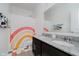 Modern bathroom featuring dual sinks with granite countertops and a shower with a rainbow curtain at 7724 Dunleer Dr, Brownsburg, IN 46112