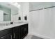 Bathroom features a dual sink vanity, a large mirror, and a shower with curtain at 7724 Dunleer Dr, Brownsburg, IN 46112
