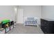 Well-organized Bedroom with a white crib, dark dresser, soft grey carpet and storage at 7724 Dunleer Dr, Brownsburg, IN 46112