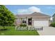 Charming single-story brick home with a manicured lawn and an attached two car garage at 7724 Dunleer Dr, Brownsburg, IN 46112
