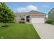 Charming brick home featuring a well-maintained lawn, mature tree, and two-car garage at 7724 Dunleer Dr, Brownsburg, IN 46112
