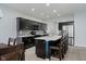 Modern kitchen features dark cabinetry, stainless steel appliances, and a large center island with bar seating at 7724 Dunleer Dr, Brownsburg, IN 46112