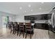 Bright kitchen with stainless appliances, dark cabinets, an island with seating, and sliding glass door to the deck at 7724 Dunleer Dr, Brownsburg, IN 46112
