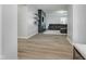 Open-concept living room with wood floors, a stylish accent wall and a comfortable sofa at 7724 Dunleer Dr, Brownsburg, IN 46112