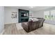 Cozy living room featuring an electric fireplace and mounted TV at 7724 Dunleer Dr, Brownsburg, IN 46112