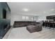 Inviting living room with modern furniture, open to the kitchen and dining area at 7724 Dunleer Dr, Brownsburg, IN 46112