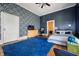 Stylish bedroom with blue accent wall, geometric wallpaper, and hardwood floors at 8 W Jackson St, Knightstown, IN 46148