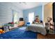 Cozy bedroom with cloud wallpaper, plush toys, and blue carpet at 8 W Jackson St, Knightstown, IN 46148