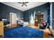 Stylish bedroom with hardwood floors, a plush blue rug, and a cozy seating area at 8 W Jackson St, Knightstown, IN 46148