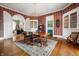 Spacious dining room with hardwood floors, period wallpaper, and ample natural light at 8 W Jackson St, Knightstown, IN 46148
