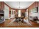 Formal dining room featuring hardwood floors, elegant wallpaper, and a classic chandelier at 8 W Jackson St, Knightstown, IN 46148