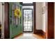 Inviting entryway with an ornate green door, hardwood floors, and stylish decor at 8 W Jackson St, Knightstown, IN 46148