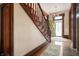 Classic entryway featuring wooden stairs, hardwood floors, and a view of the ornate front door at 8 W Jackson St, Knightstown, IN 46148