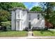 Charming white home featuring a bay window, front porch with seating, and well-manicured lawn at 8 W Jackson St, Knightstown, IN 46148
