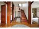 Spacious hallway featuring hardwood floors, wood trim and staircase at 8 W Jackson St, Knightstown, IN 46148