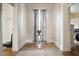 Hallway with hardwood floors, a small table with plant, and entryways to multiple rooms at 8 W Jackson St, Knightstown, IN 46148
