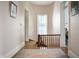Bright hallway with hardwood floors, a staircase, and natural light streaming through the window at 8 W Jackson St, Knightstown, IN 46148