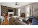 Cozy living room with fireplace, dark accent wall, hardwood floors, and comfortable seating at 8 W Jackson St, Knightstown, IN 46148