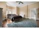 Serene main bedroom with bay windows, hardwood floors, and a comfortable bed at 8 W Jackson St, Knightstown, IN 46148