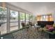 Relaxing sun room with cozy chairs, a table, and views of the backyard at 8 W Jackson St, Knightstown, IN 46148