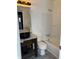 Bright bathroom with a modern vanity, vessel sink, decorative mirror, and a shower-tub combination at 8109 E Penway St, Indianapolis, IN 46226