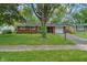 Charming single story brick home with a tree in the front yard and an attached garage at 8109 E Penway St, Indianapolis, IN 46226
