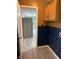 Mud room, includes oak cabinets and a blue tiled wall at 8109 E Penway St, Indianapolis, IN 46226