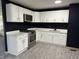 Modern kitchen with white cabinets, stainless steel appliances, and quartz countertops at 8109 E Penway St, Indianapolis, IN 46226
