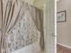 Bathtub featuring a modern-patterned shower curtain, next to a white door at 811 Gazebo Way, Greenwood, IN 46142
